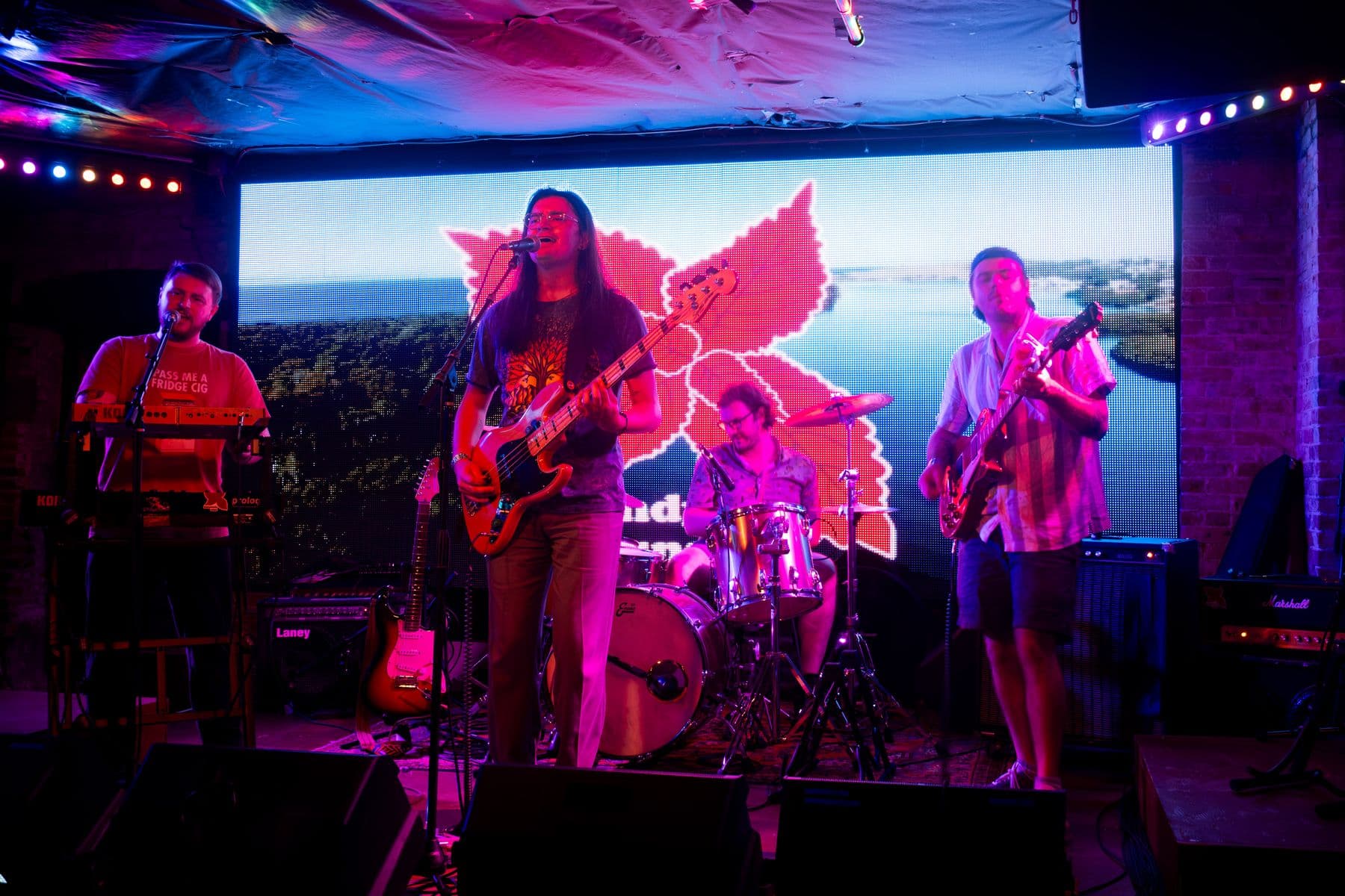 Burgundy Suns performing in front of a projection